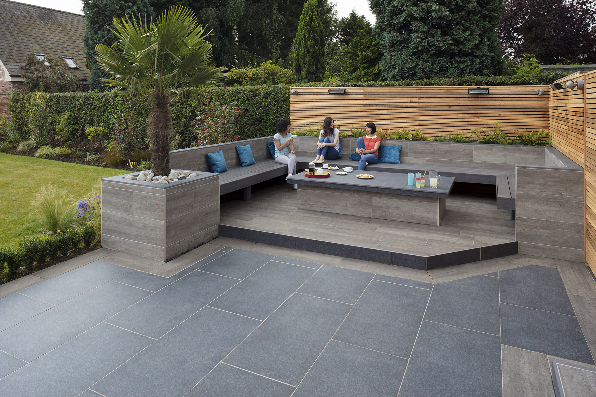 SYMPHONY® Classic in Blue People sat at a wooden garden seating area