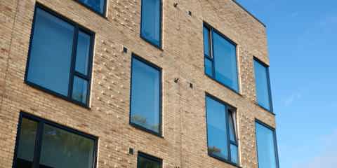 A block of flats with windows built using Marshalls Glencoe Vintage Stock Facing Brick