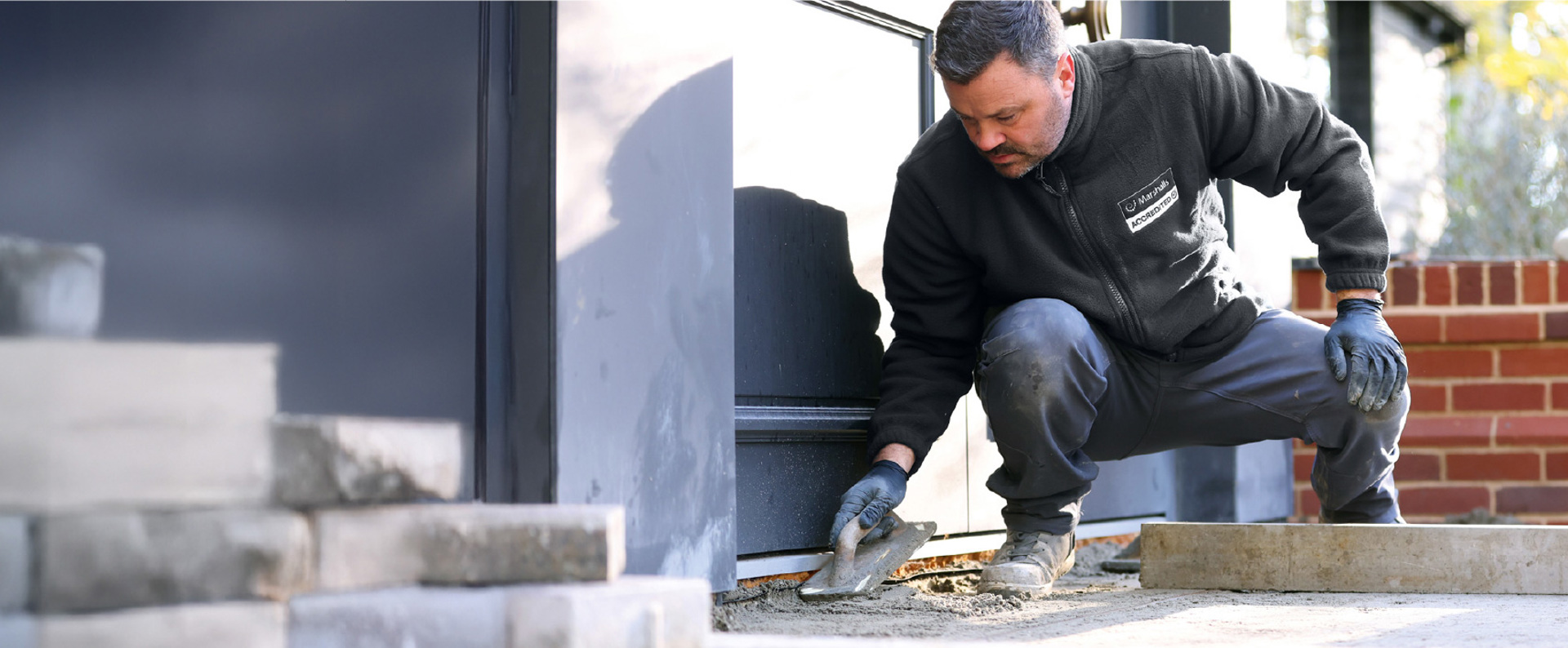 An accredited member laying a driveway