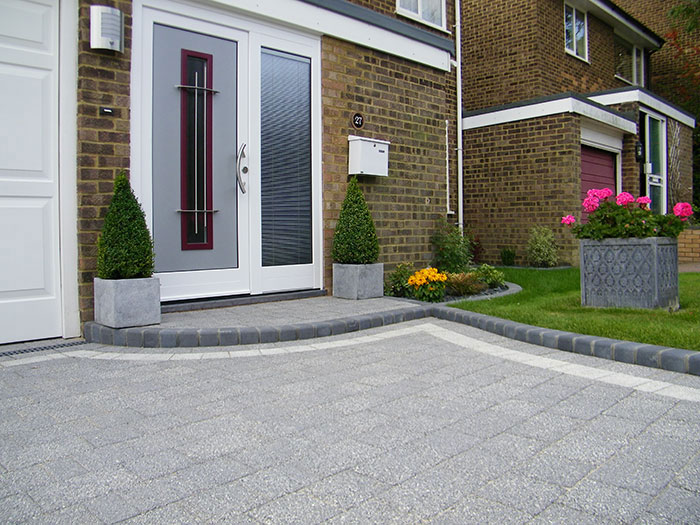 Drivesett Argent® in Dark A pale grey tiled patio