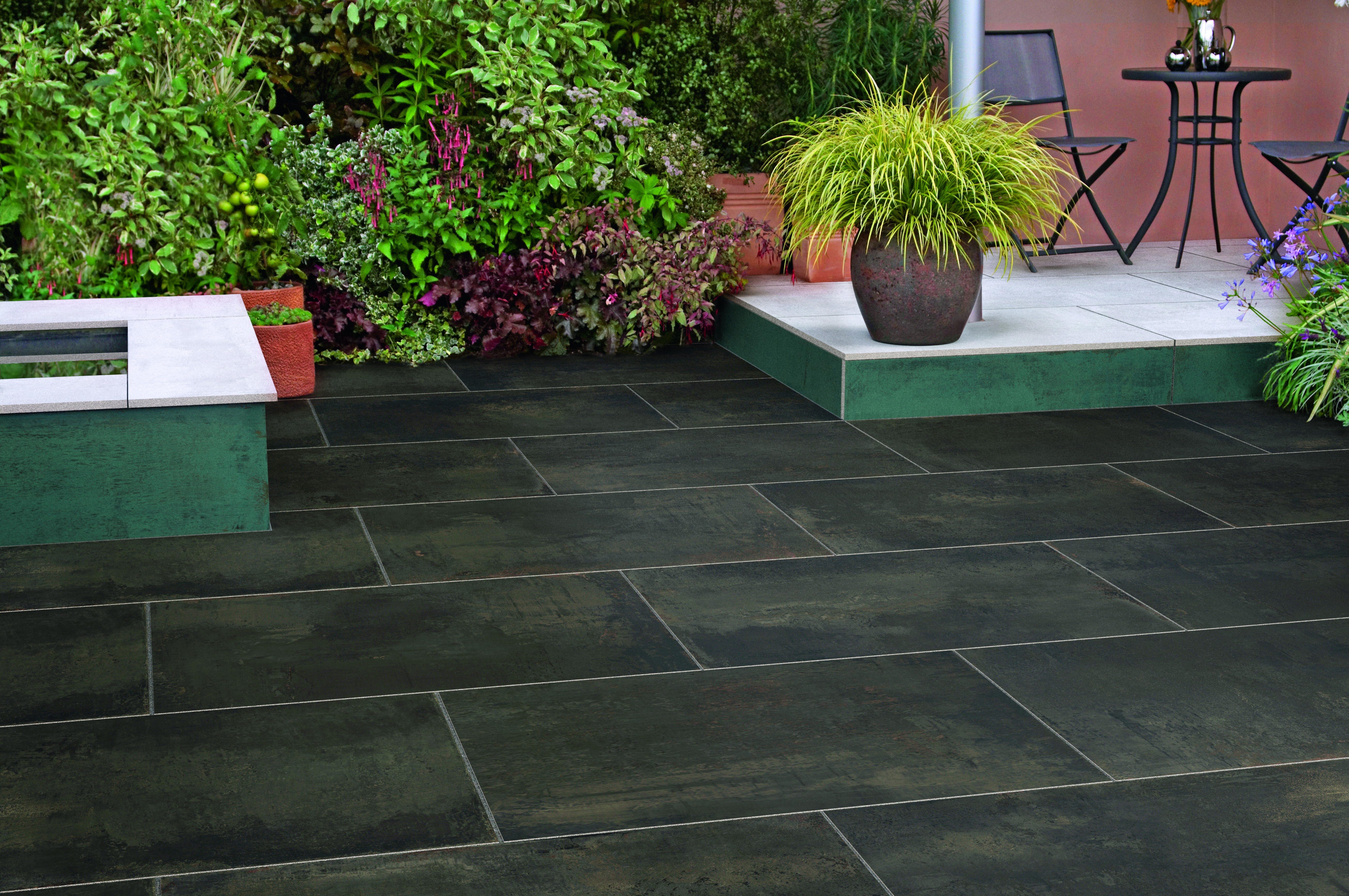 SYMPHONY® Elements Metallic Brown garden paving with a raised level in the background