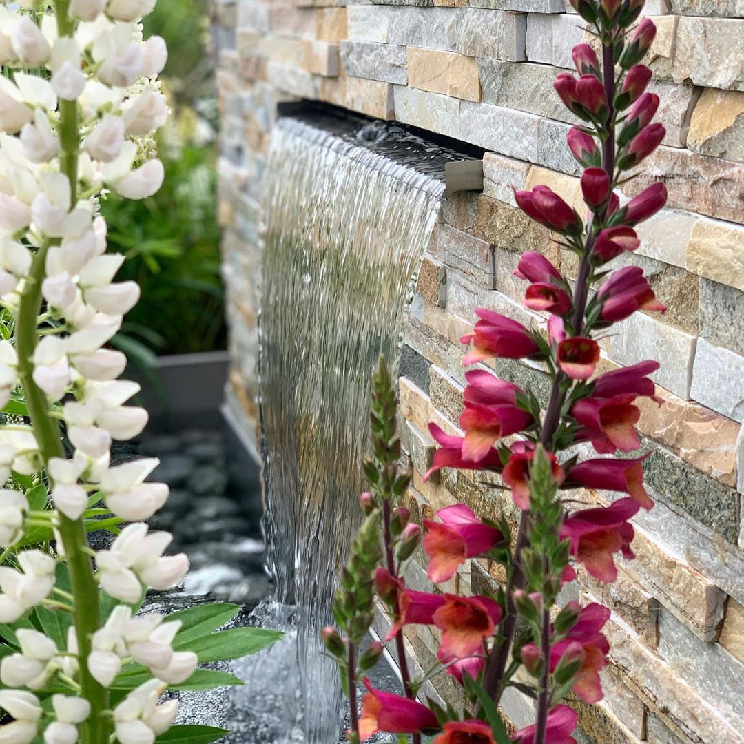 Stoneface® Drystack Veneer Walling in Harvest Mix A water feature emerging out of drystack veneer walling