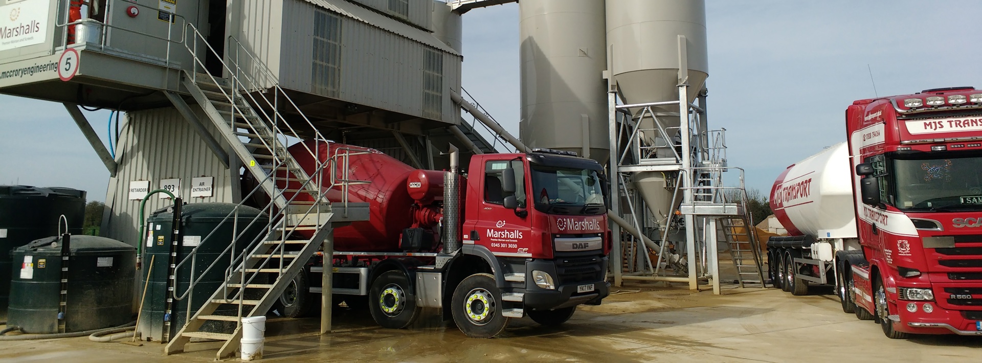 Marshalls red lorry collecting screed for delivery