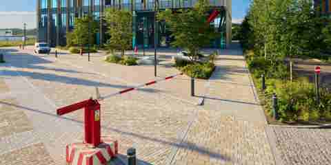 Modal X paving laid underneath a red and white safety barrier