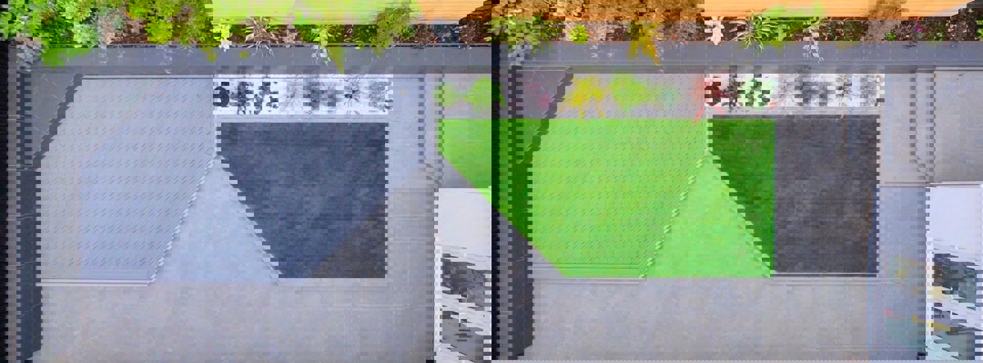 Birdseye view of a modern garden with Marshalls Arrento silver paving and a small seating area 