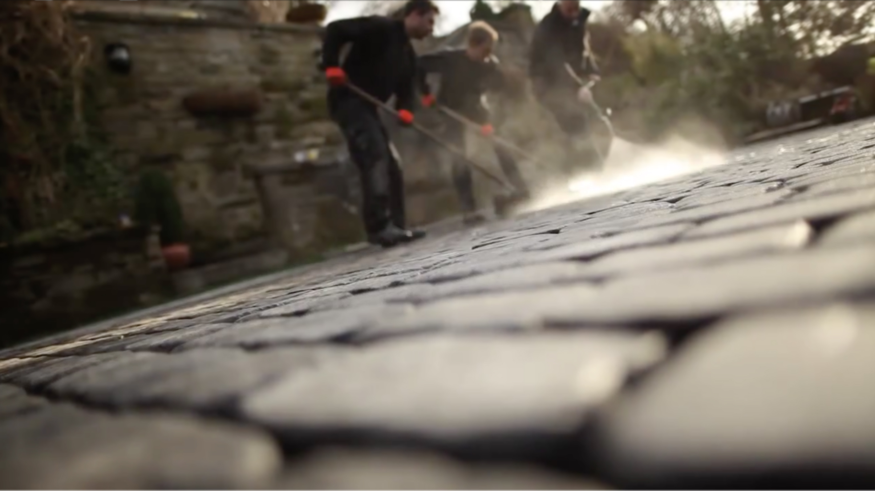 People cleaning a driveway